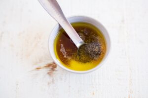 honey, olive oil, salt, pepper and garlic powder in a small bowl
