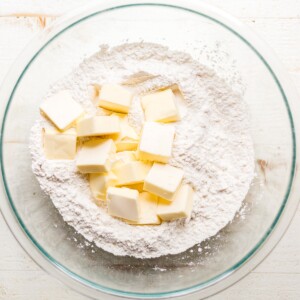 cold butter cubed in a bowl with gluten free flour