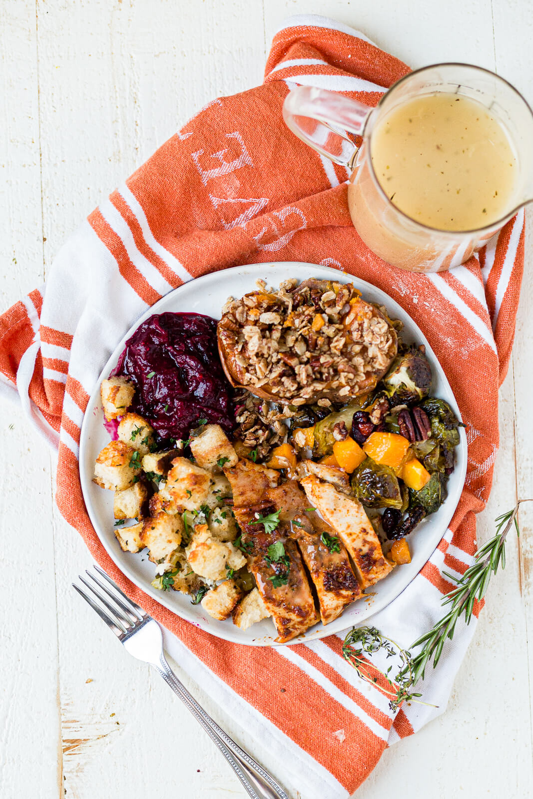 easy thanksgiving dinner recipes all on one plate with gravy and fresh herbs