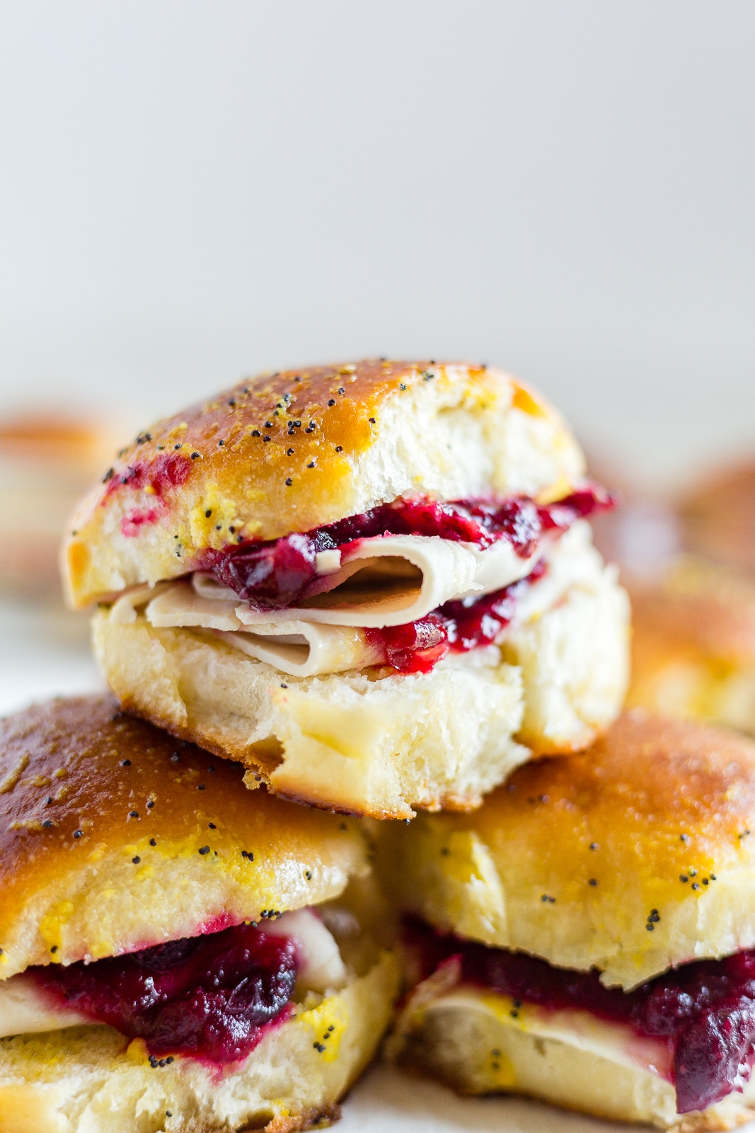 3 leftover turkey sandwiches on  homemade buns with cranberry sauce