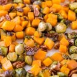 roasted brussel sprouts and squash on a sheet pan