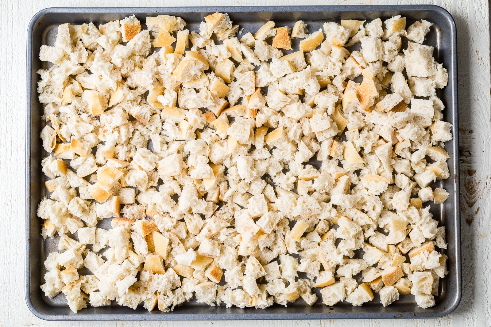 dry sourdough bread for stuffing on a sheet pan