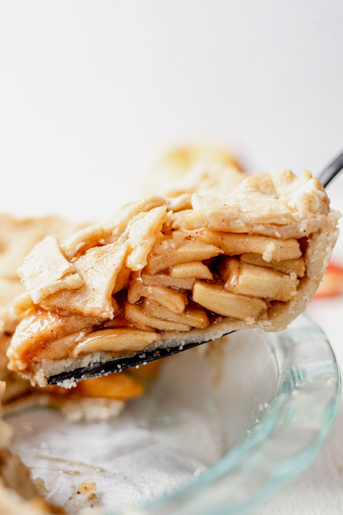 a large slice of gluten free apple pie on a serving spoon