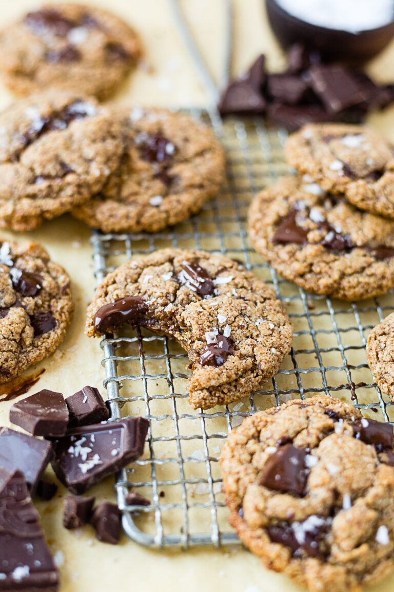 almond butter cookies on a piece of parchment paper with chocolate chunks and sea salt