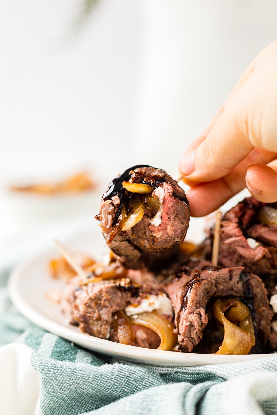 beef tenderloin wrapped around goat cheese and caramelized onion with a balsamic glaze