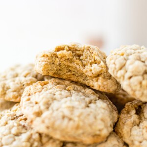 a stack of brown butter oatmeal cookies and the top one has a bite taken out