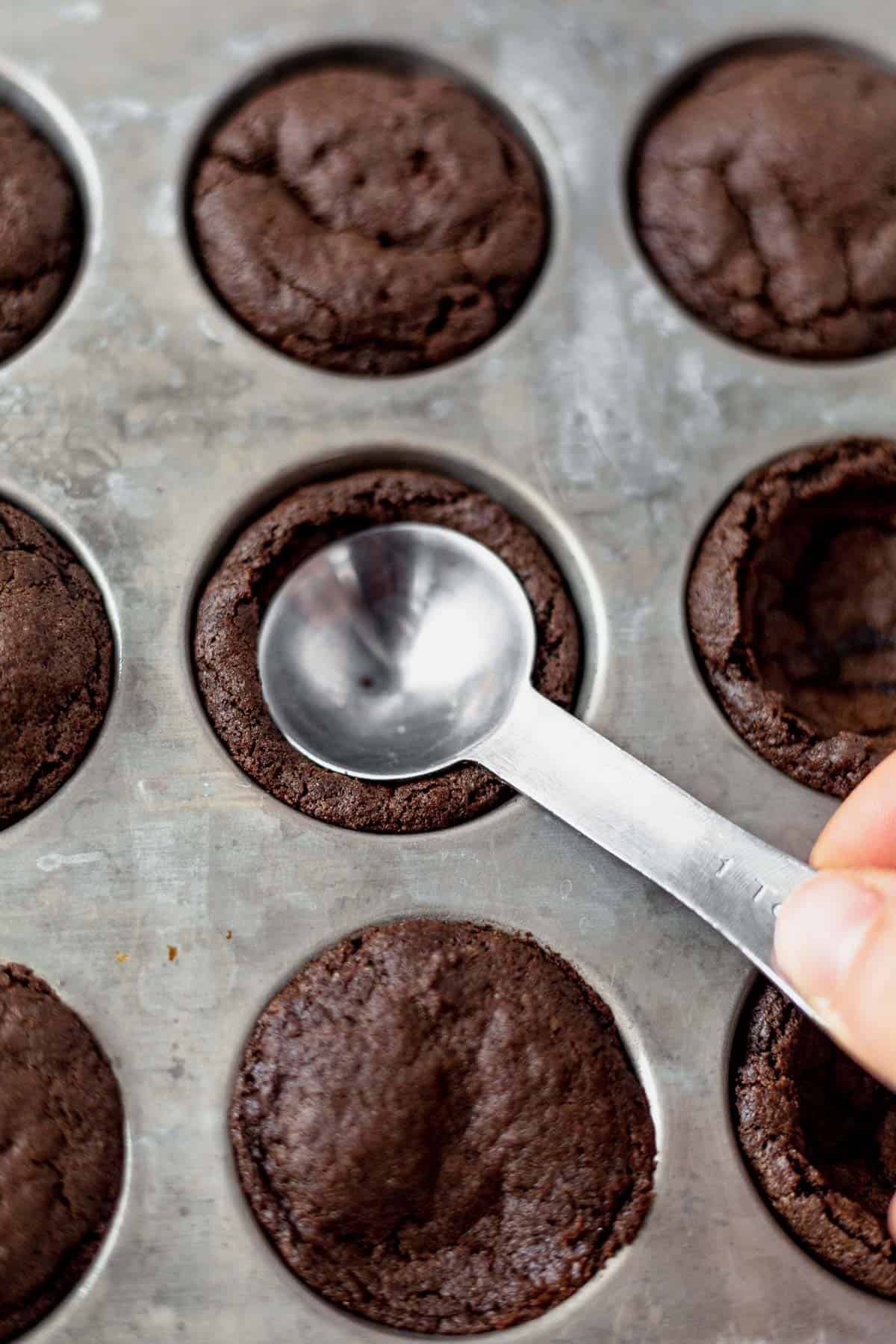 pressing a teaspoon into a hot cocoa cookie