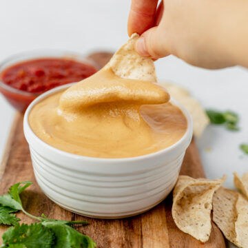 a chip covered in creamy cashew queso