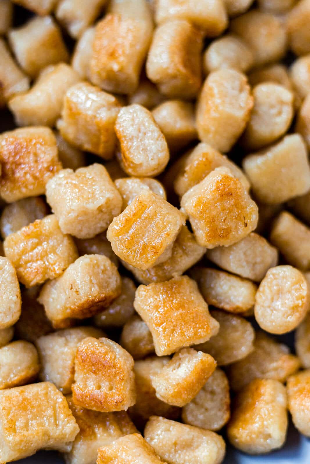 crispy cauliflower gnocchi piled in a pan