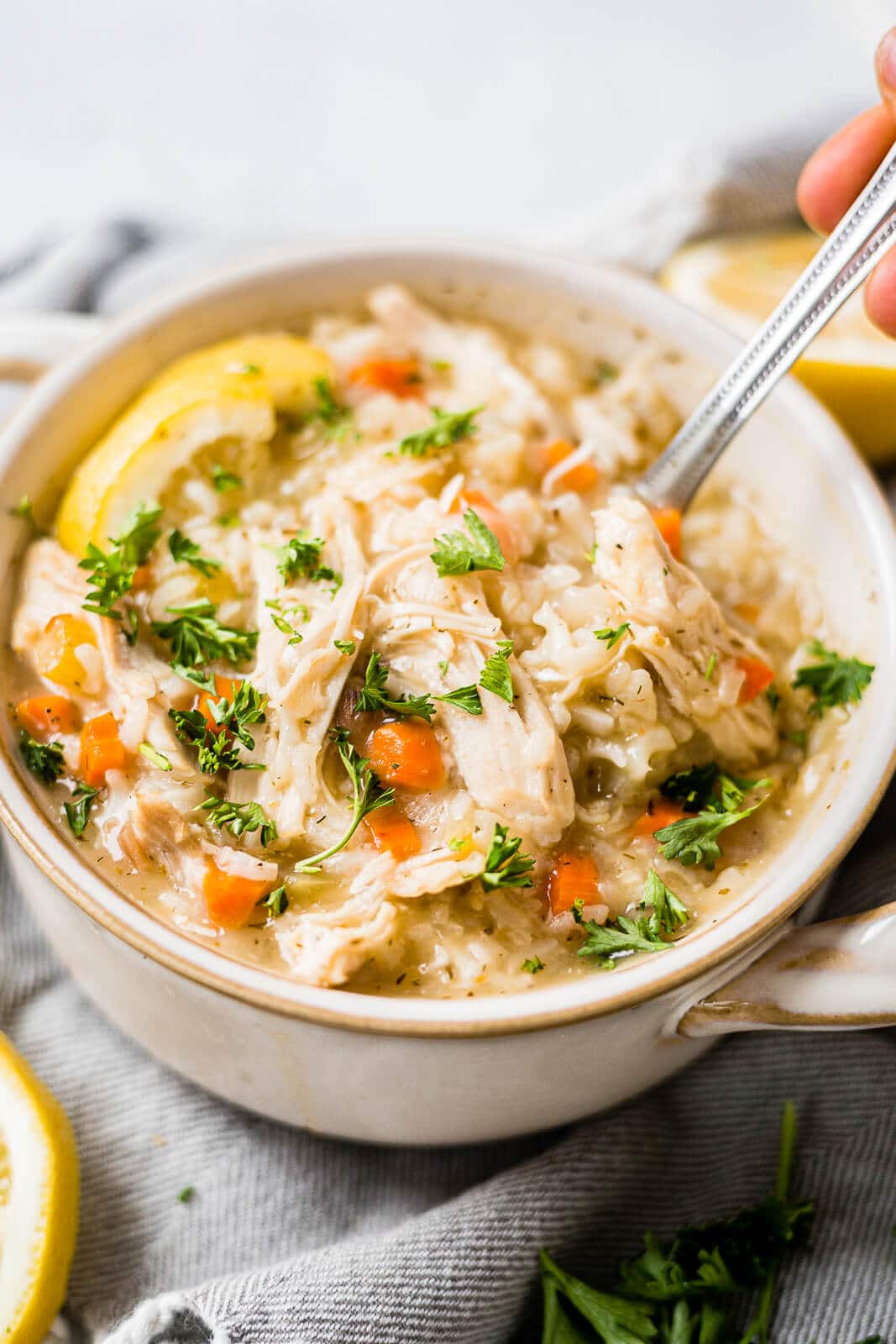 spoon scooping out this easy greek lemon chicken soup from a bowl
