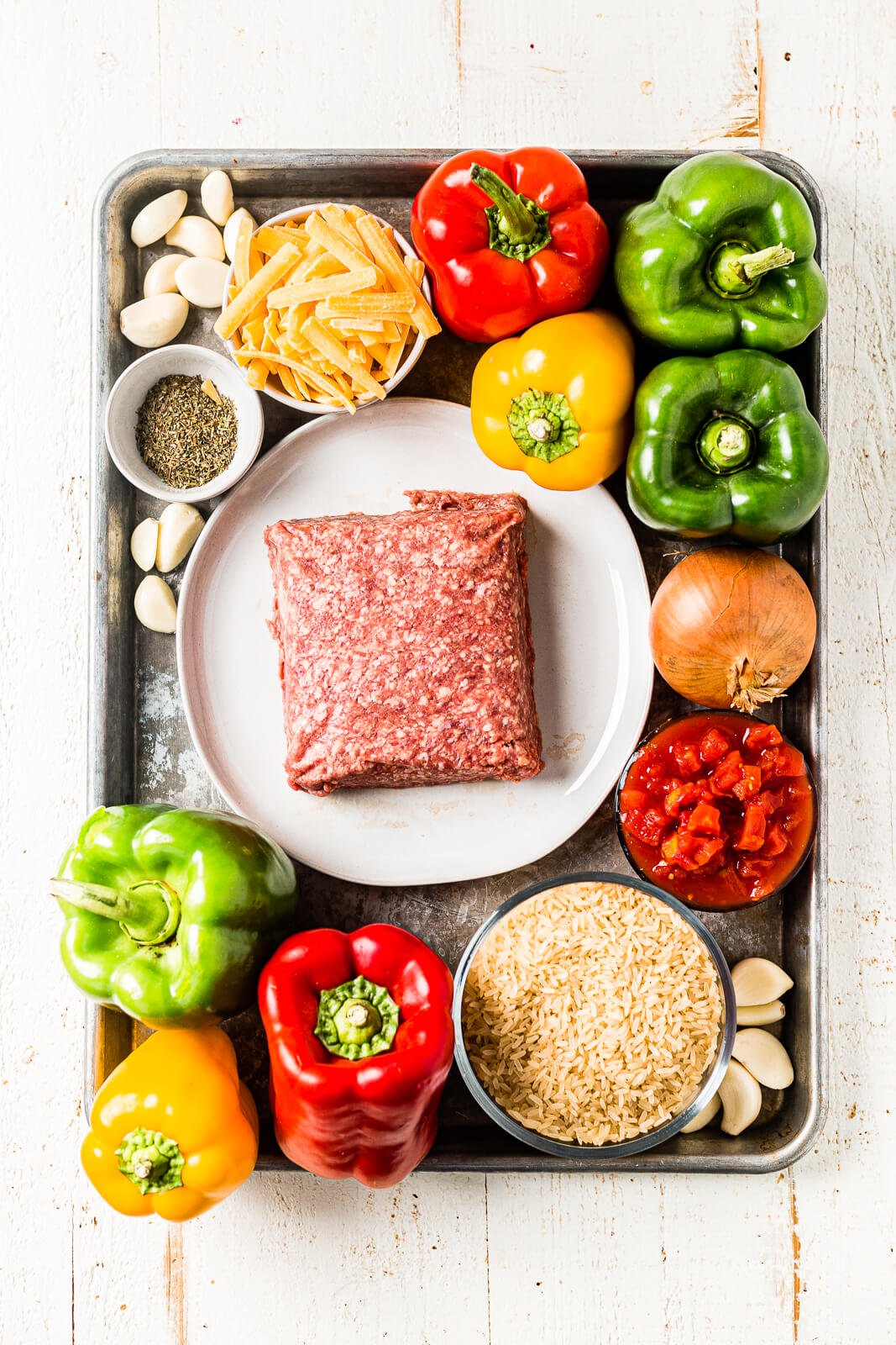 Ingredients for air fryer stuffed peppers arranged on a sheet pan before cooking