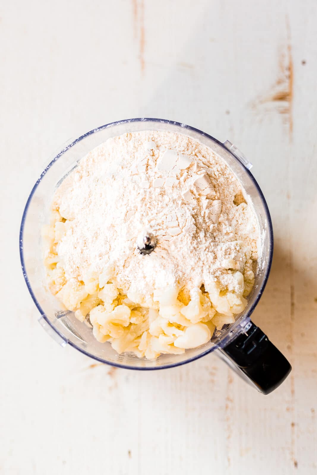 cauliflower and cassava flour in the bowl of a food processor