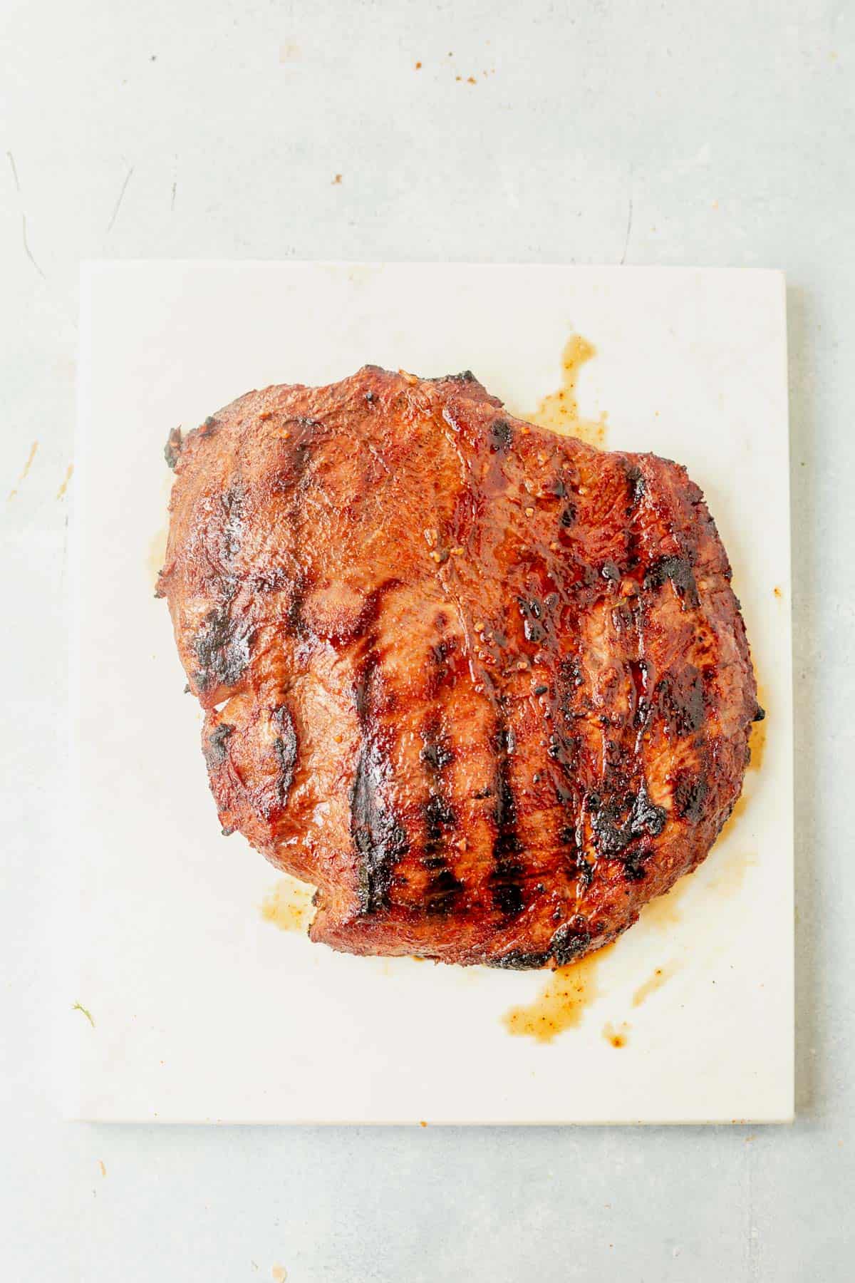 carne asada resting on a cutting board