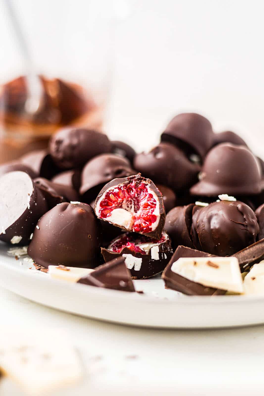 chocolate covered raspberries on a white serving plate