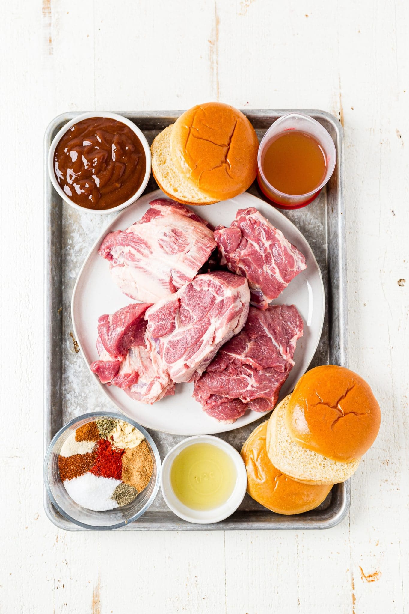 ingredients for pulled pork on a sheet pan