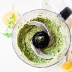arugula pesto in the bowl of a food processor