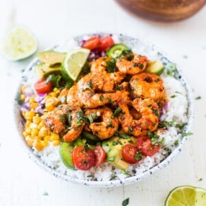 fiesta lime shrimp bowl in a white bowl topped with cilantro and lime juice