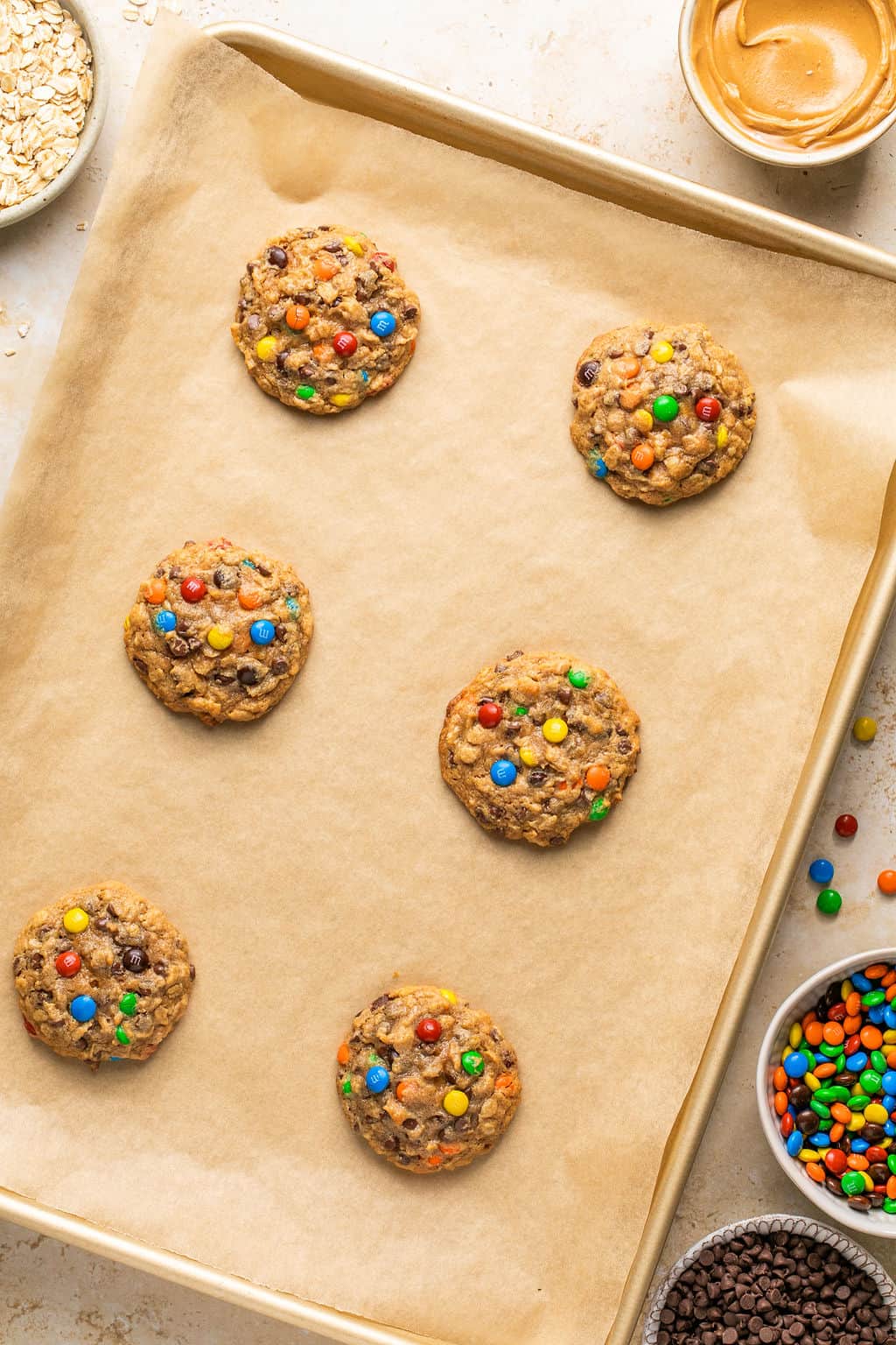 freshly baked flourless monster cookies in a cookie sheet