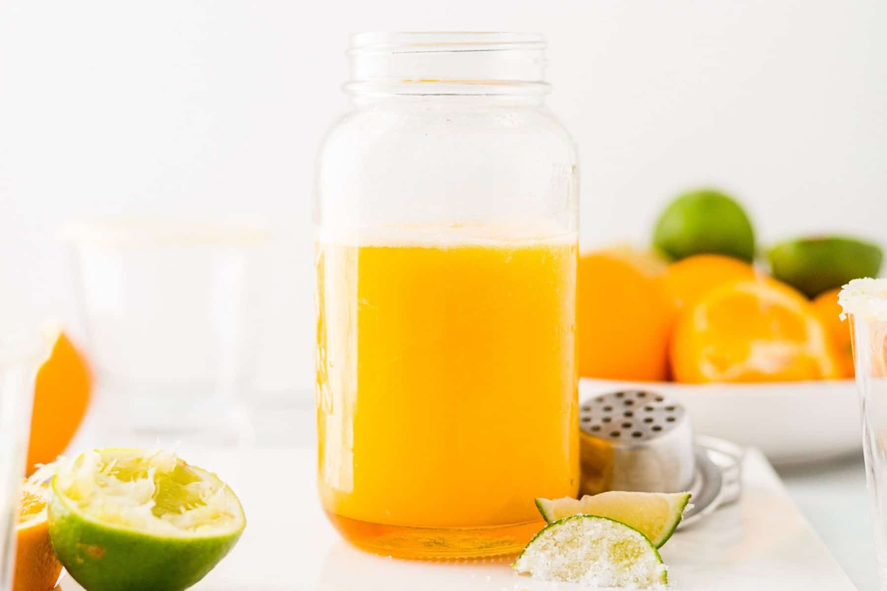 all of the ingredients for mango margaritas in a shaker jar to pour on the rocks