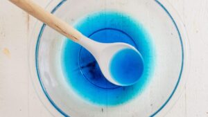 blue jello dissolved in a bowl with cold water and vodka
