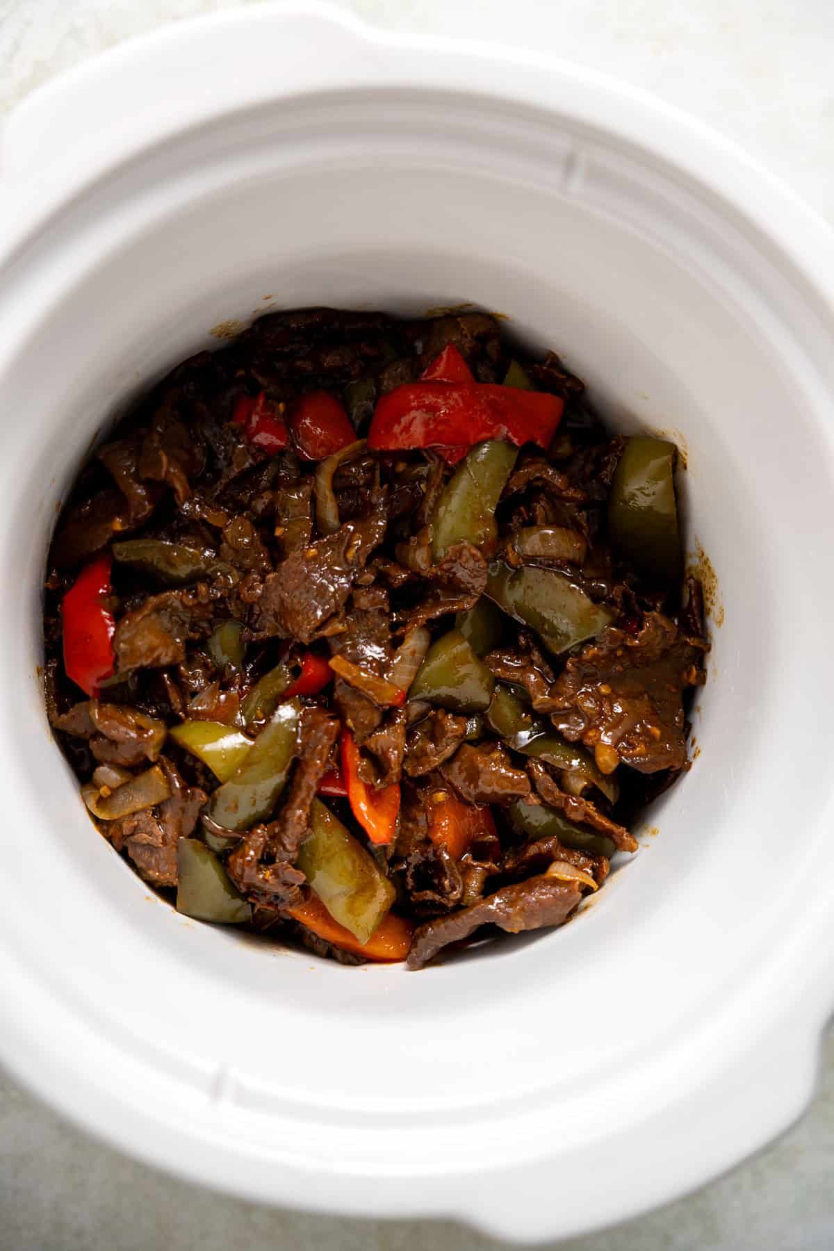 slow cooker pepper steak in a crock pot.