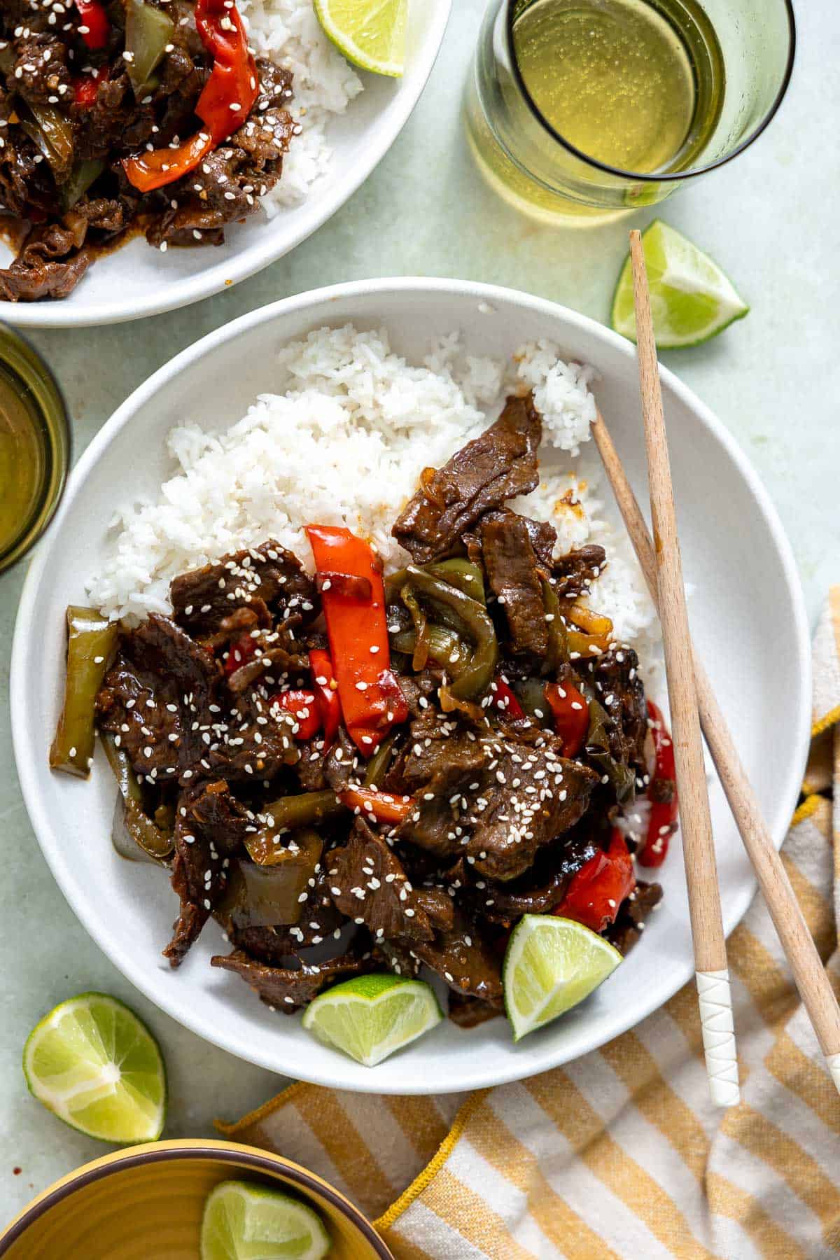 a bowl of crock pot pepper steak with chopticks.