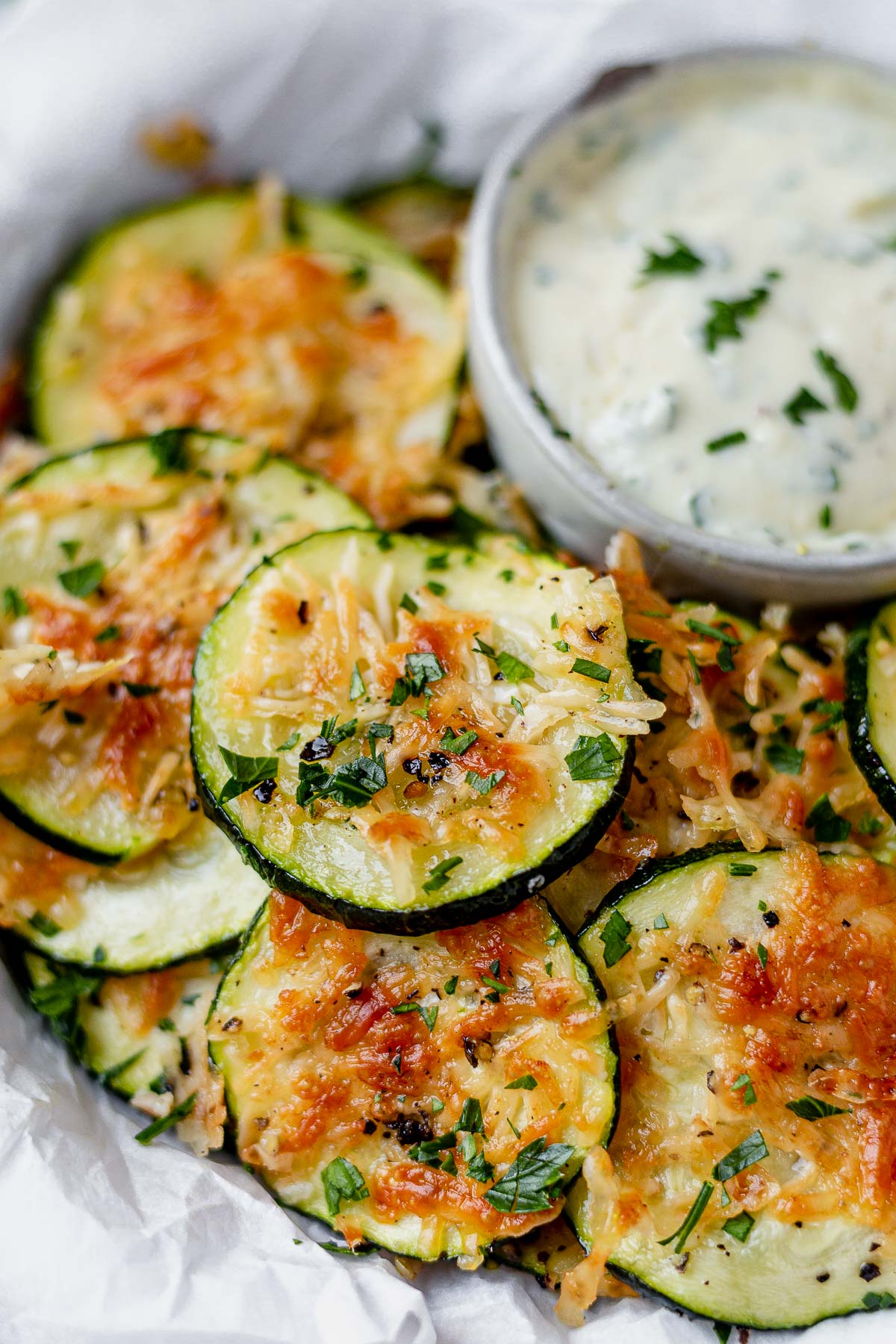 air fryer zucchini chips with crispy parmesan cheese in a bowl