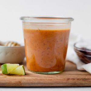 chipotle honey vinaigrette in a glass jar next to a fresh lime