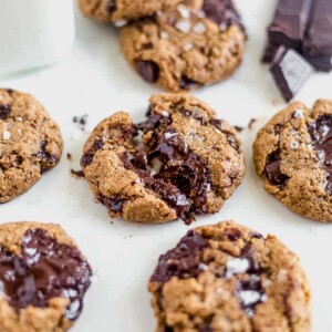 melted chocolate in the middle of a broken coconut flour chocolate chip cookie