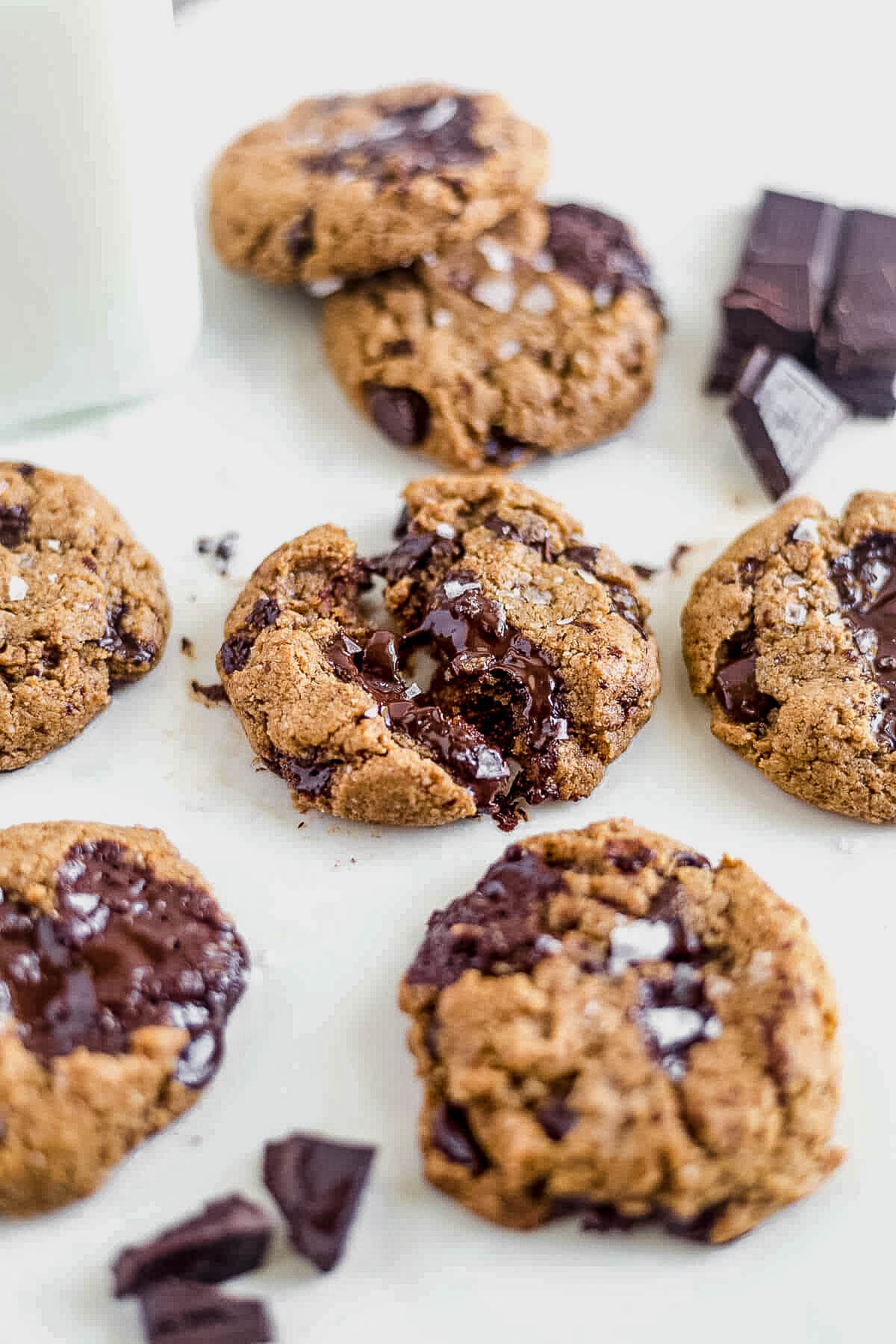 a coconut flour chocolate chip cookie broken in half with melted chocolate in the middle