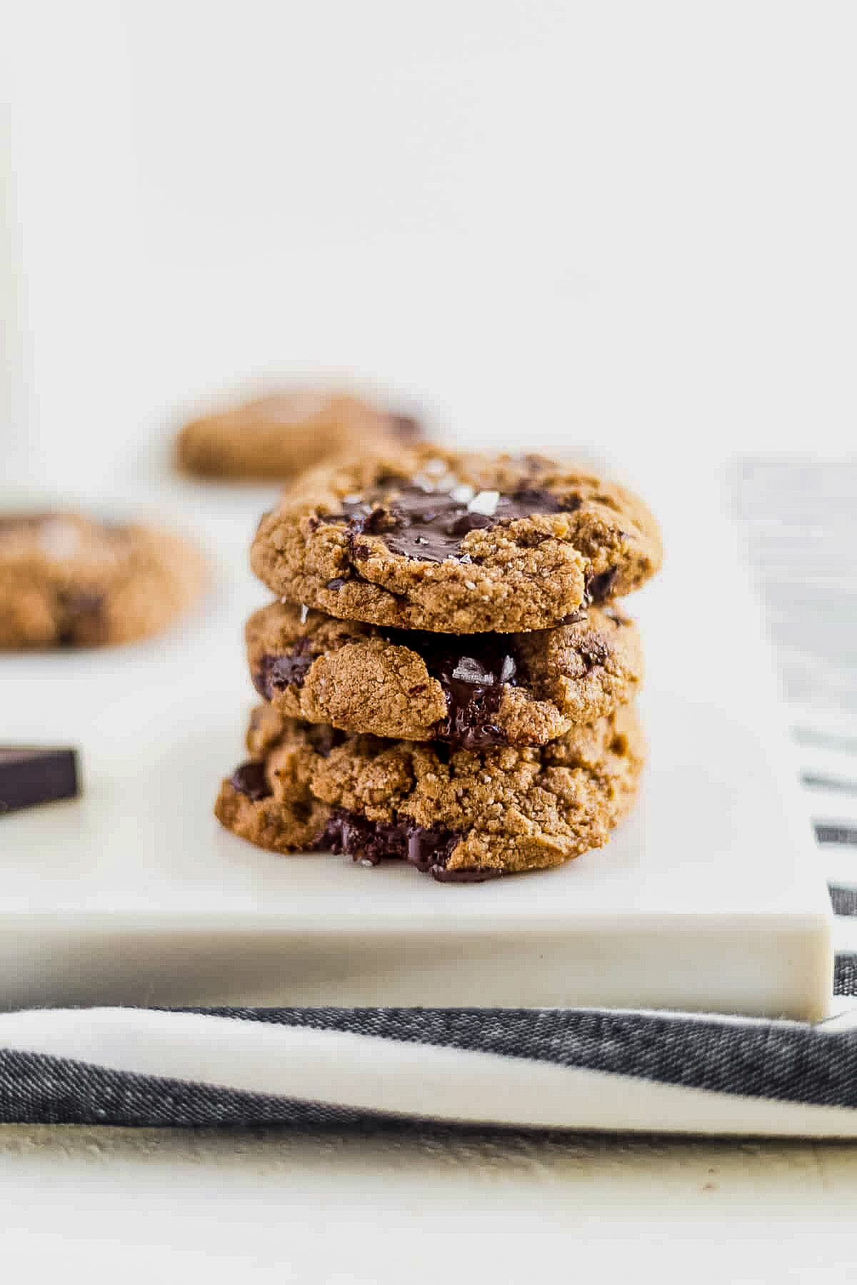 three coconut flour chocolate chip cookies stacked on top of each other