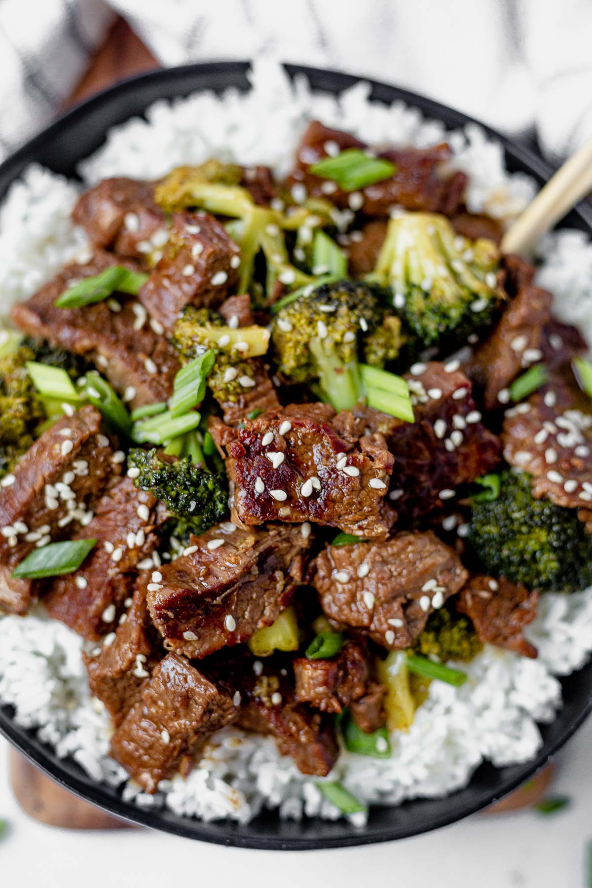 instant pot mongolian beef and broccoli over a bowl of rice