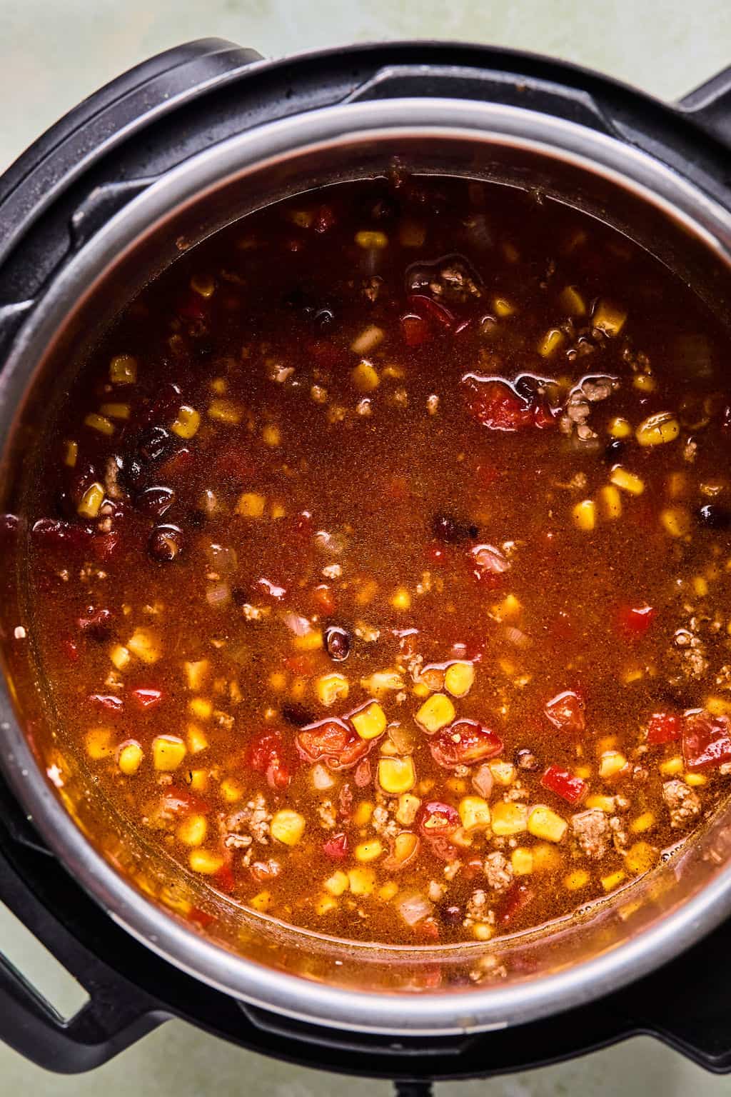 taco soup ingredients mixed together in an Instant Pot.