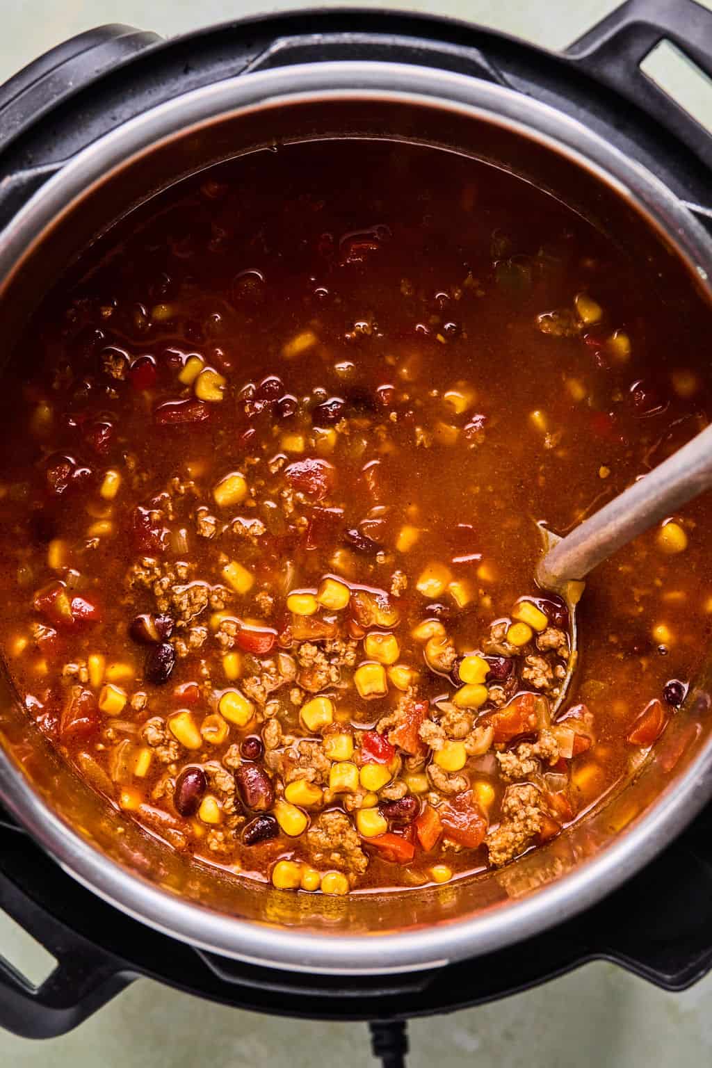 taco soup in Instant Pot with a ladle.