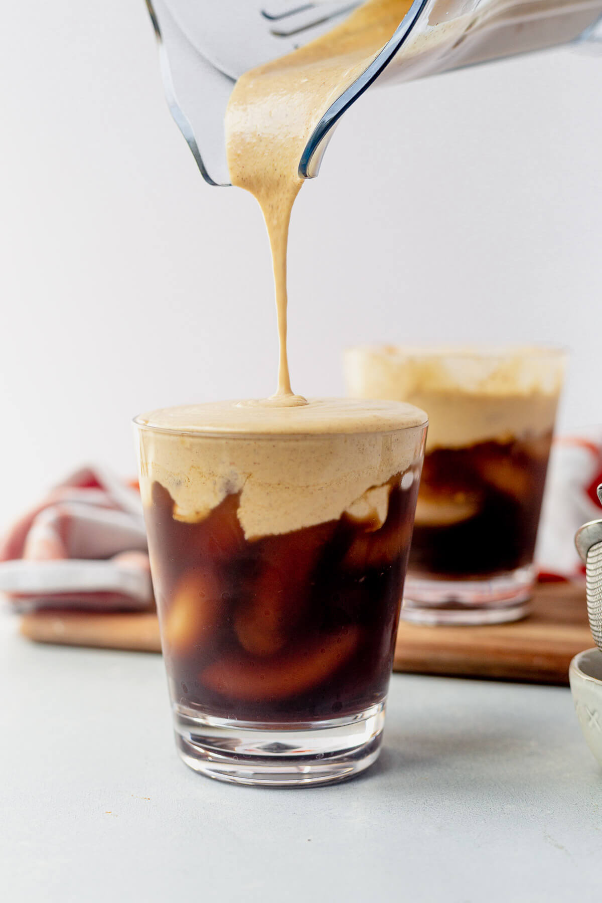 pumpkin cream cold brew recipe pouring out of a blender 