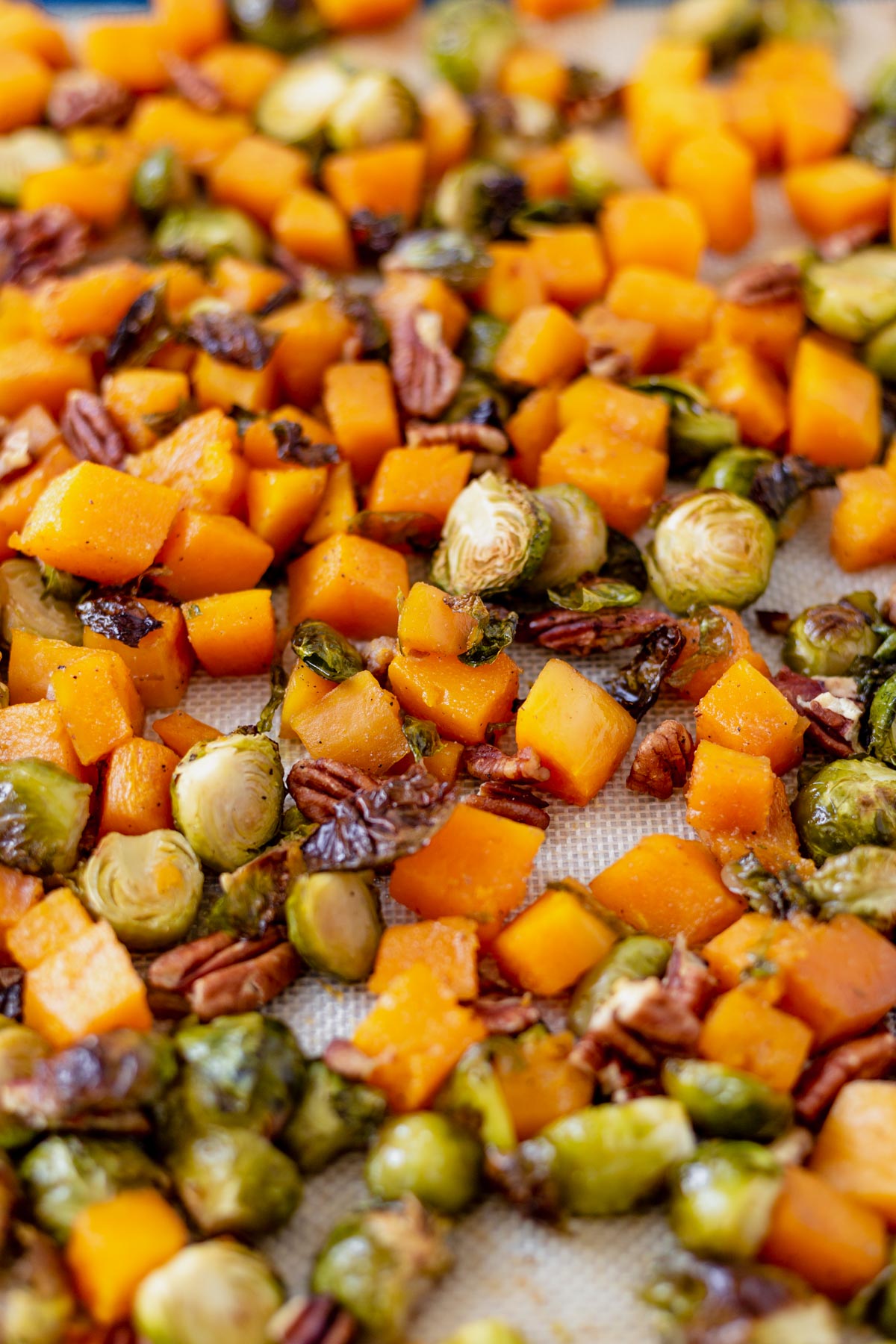roasted butternut squash and brussel sprouts on a sheet pan