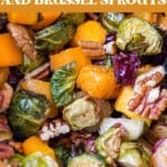 roasted butternut squash and brussel sprouts on a sheet pan with pecans and cranberries