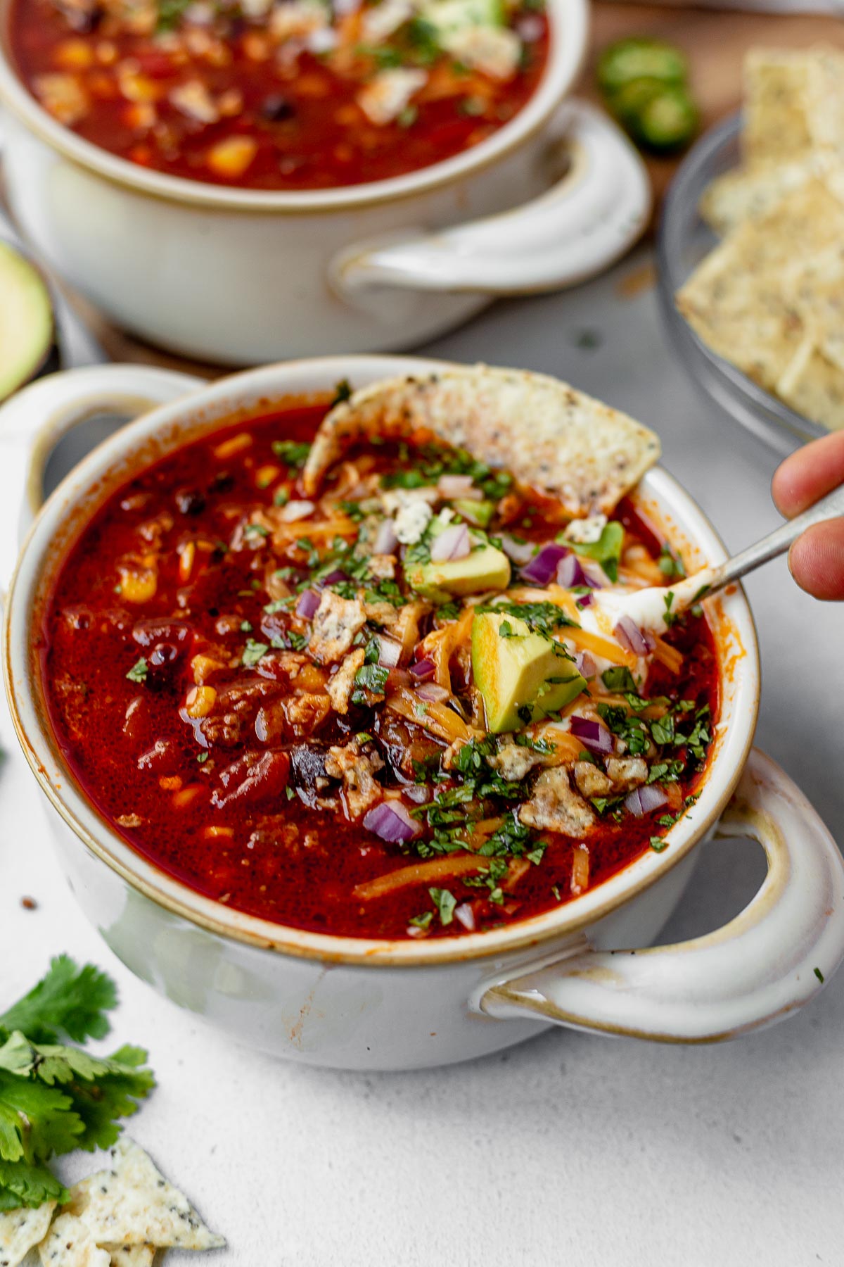 a spoon scooping a spoonful of instant pot taco soup from a soup bowl