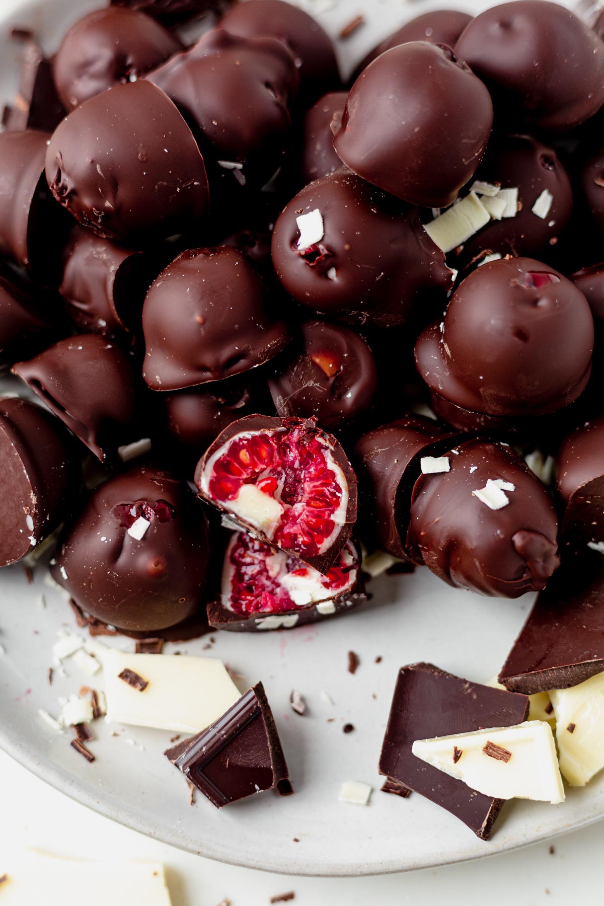 a chocolate covered raspberry cut in half with layers of white and dark chocolate