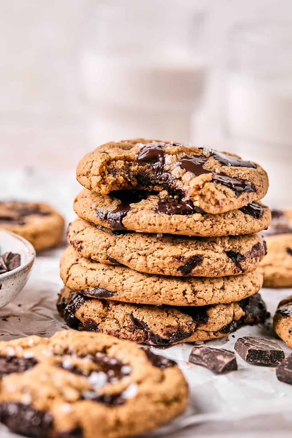 a stack of coconut flour cookies with a bite taken out of the top one.