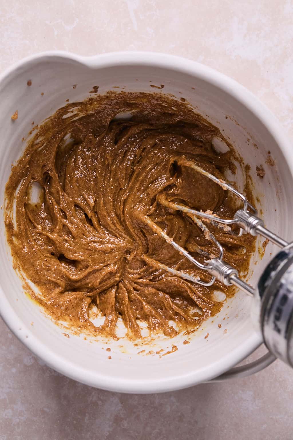 mixing coconut sugar, almond butter, eggs, and vanilla in a mixing bowl.