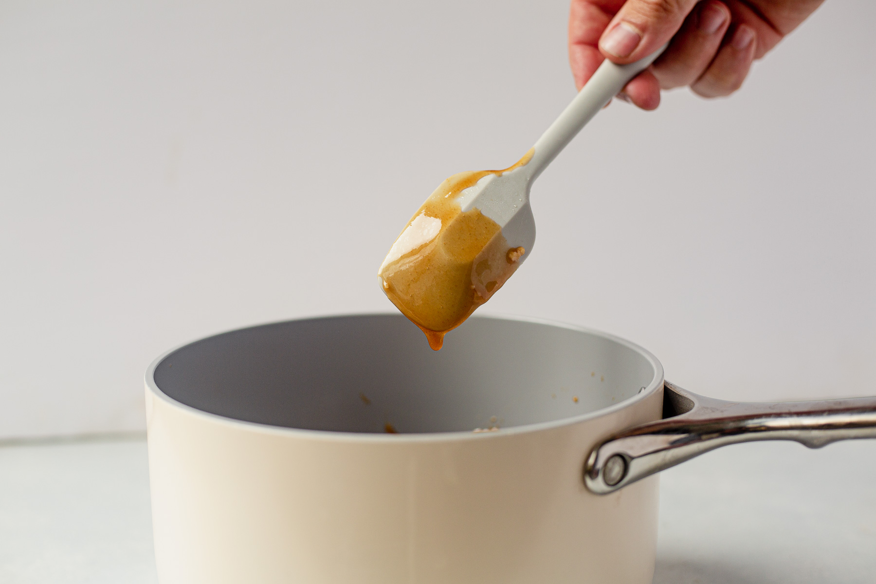 hawaiian chicken kabob sauce in a pan coating the back of the spoon to show it's done