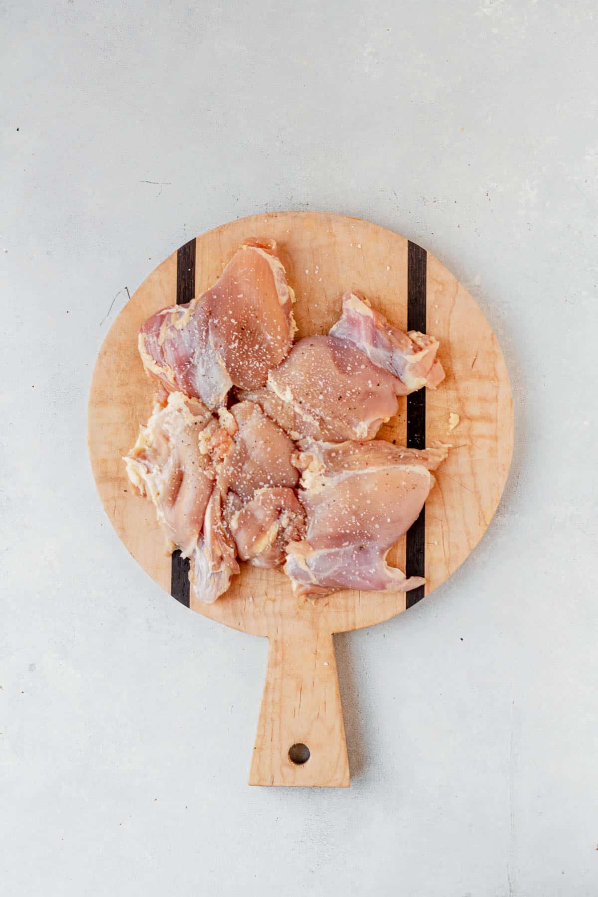 seasoned raw thicken thaws on a cutting board