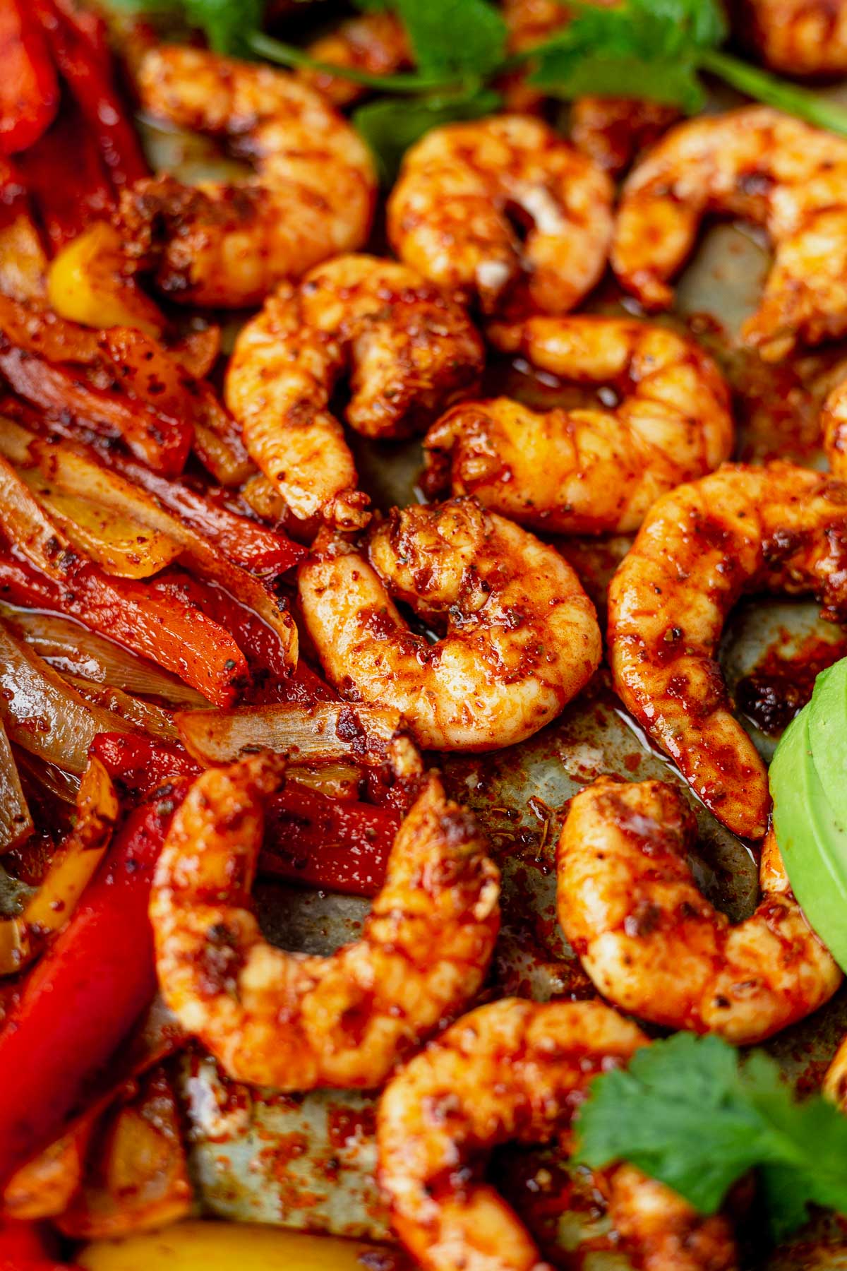 shrimp fajitas cooked on a sheet pan with fresh cilantro