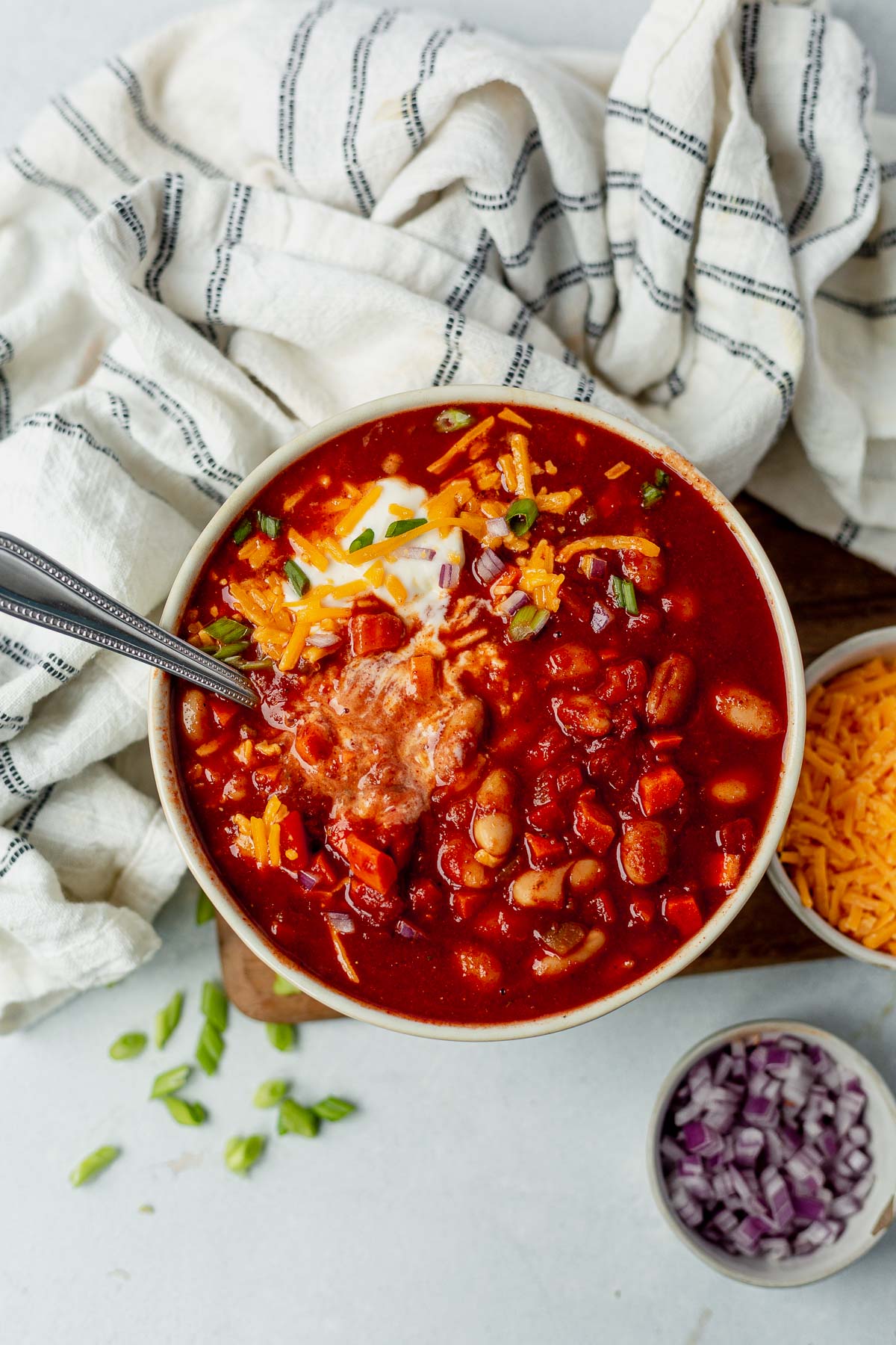 slow cooker vegetarian chili in a bowl with sour cream and cheese