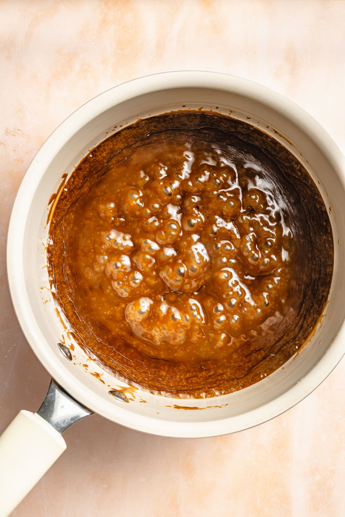 paleo caramel sauce bubbling in a saucepan.