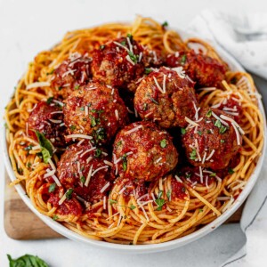homemade gluten free meatballs on top of a bowl of spaghetti