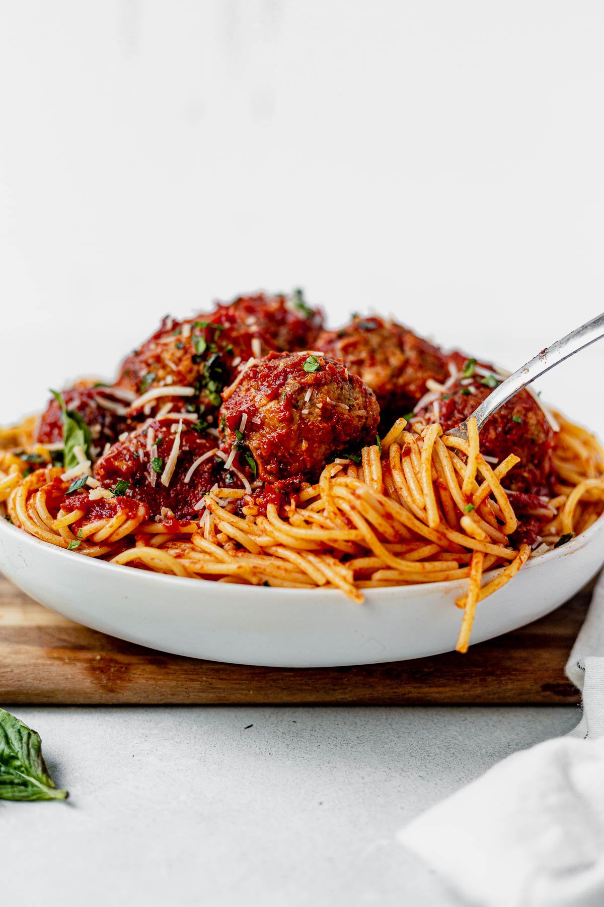 gluten free meatballs on top of spaghetti with a fork twisted in it