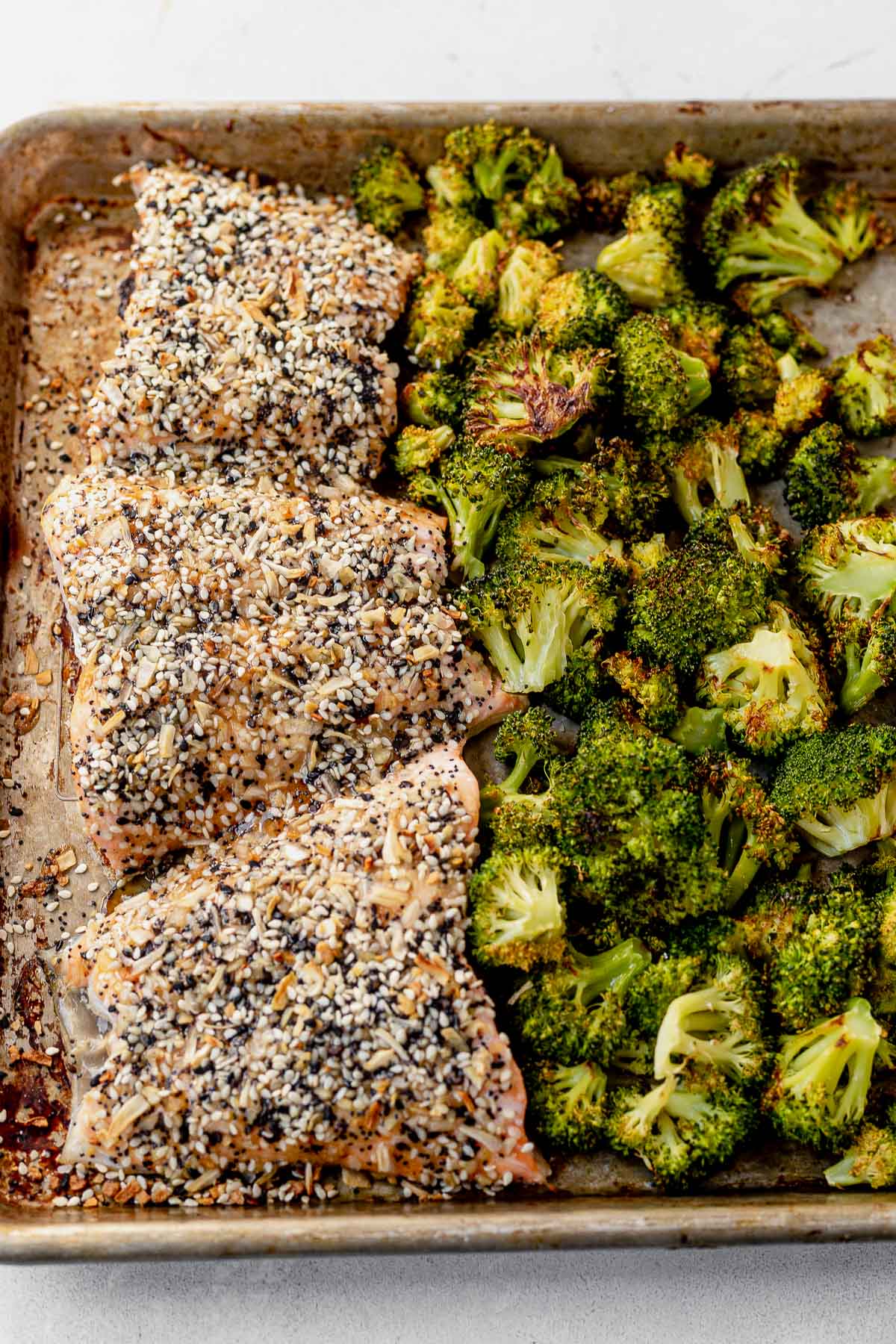 everything bagel salmon and roasted broccoli on a sheet pan