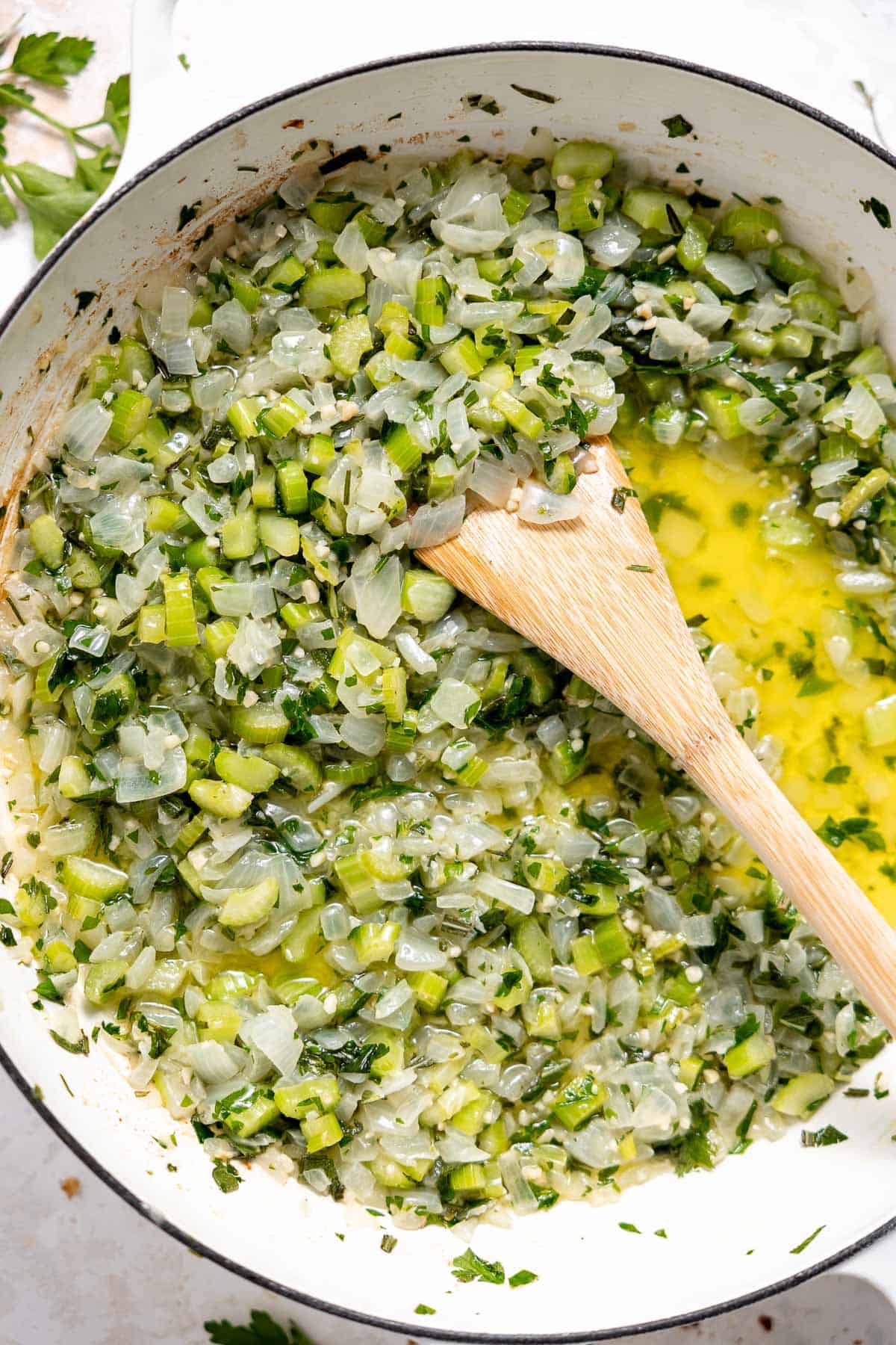 cooked onion, celery, and herbs in a pan with butter.